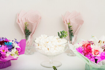 White meringue in glass vase on holiday table. Celebration concept