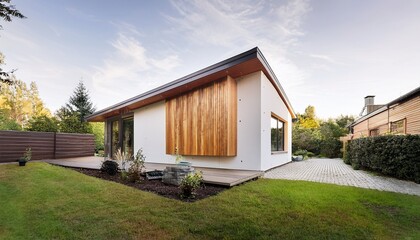 modern small house with wood and white facade sloped roof and front garden