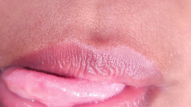 Close up Macro of Indian teenage girl lips doing various types of expressions. lift, Frown, grimace, moue, scowl, pout, Kiss, smooch, smack, peck, graze, caress, skim