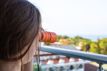 girl looking through binoculars