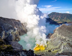Fototapeta premium The Ijen volcano crater with its turquoise acid lake, billowing sulfuric gas clouds, and bright yellow sulfur deposits.