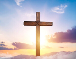 Wooden cross silhouetted against a colorful sky with sunlight and clouds