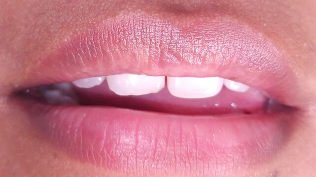 Close up Macro of Indian teenage girl lips doing various types of expressions. lift, Frown, grimace, moue, scowl, pout, Kiss, smooch, smack, peck, graze, caress, skim