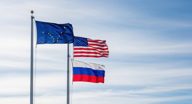European union, United States, and Russia flags flying high on flagpoles against a clear blue sky, symbolizing international relations and cooperation.