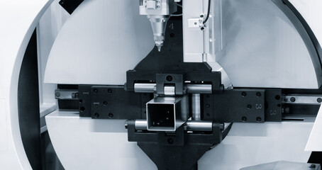 Industrial machine laser cutting metal, industrial concept background.