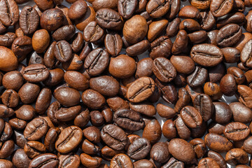 Roasted coffee beans as a background. Closeup. Macro photo top view.