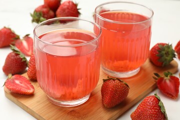 Tasty compot and strawberries on white table, closeup