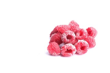 Heap of frozen raspberries on white background, space for text