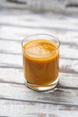 Mango smoothie on bright background. Soft focus. Copy space.	
