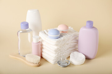 Baby accessories and cosmetic products on beige background