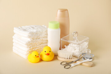 Baby accessories and cosmetic products on beige background