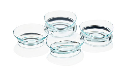Many transparent contact lenses isolated on white