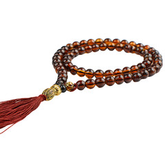 Elegant amber prayer beads with a rich tassel and ornate golden accents, perfect for spiritual practice and mindful reflection