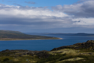 Beautiful northern landscape, sea bay and summer tundra on a sunny day.
