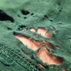 closeup there is so many hole on the broken old green bamboo cotton clothes texture