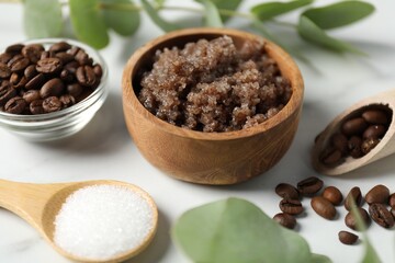 Natural body scrub and ingredients on white table, closeup