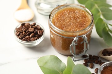 Natural body scrub and ingredients on white table, closeup