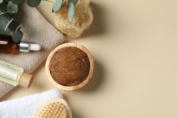 Natural body scrub and ingredients on beige table, flat lay. Space for text