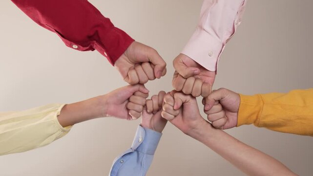 Panoramic video happy asian startup company employee wearing colorful casual cloth sit around together put fist together symbol good teamwork, harmony team, positive environment workplace. Synergic