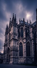 Fototapeta premium Gothic cathedral at twilight, moody clouds and detailed stonework