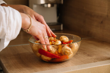 Preparing fresh vegetables in a glass bowl for cooking in a cozy kitchen setting