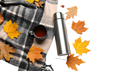 Autumn still life with thermos, tea mug, plaid and falling maple leaves on transparent background