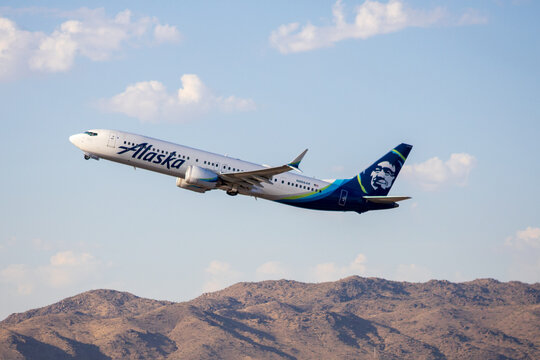 Alaska Airlines plane taking off at sunrise at Phoenix Sky Harbor Airport
