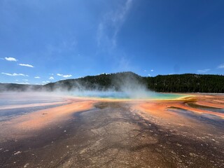 Steam rises above the colorful Grand Prismatic Spring, one of Yellowstone’s most famous geothermal features.