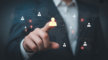 Person pointing at a glowing person icon on a world map network global connection