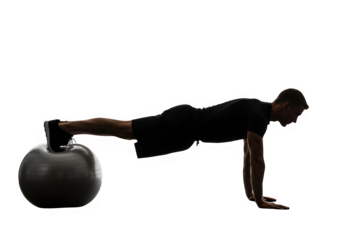 Man performing plank exercise on stability ball in fitness studio  isolate