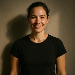 Obraz premium Smiling young caucasian woman in black shirt against neutral background
