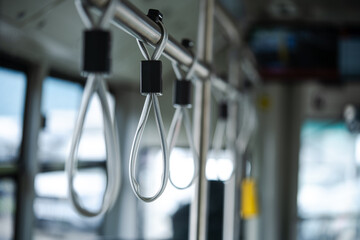 Close up shot of hand handles on public transport.