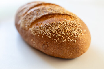 Golden brown sesame bread loaf with a crusty exterior, showcasing a delightful texture and inviting aroma.