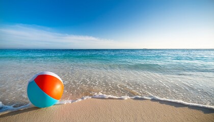 a vibrant beach ball rests on the soft sand as gentle waves lap at the shoreline the clear turquoise water sparkles under the warm sunlight creating a perfect summer atmosphere
