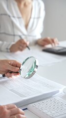 Group of accountants are working together, using a magnifying glass and a calculator, to audit financial reports in office. Audit and taxes in business