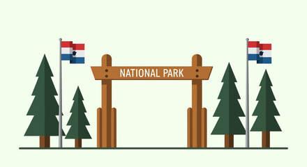Entrance gate to a national park, adorned with flags, surrounded by evergreen trees, inviting visitors to explore nature.