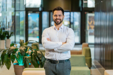 Confident male businessman in formal clothing looking at the camera and smiling. Handsome man...