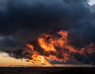 sky covered with dark clouds with red fire visible behind them