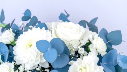 Close-up of a bouquet of white flowers and eucalyptus leaves.