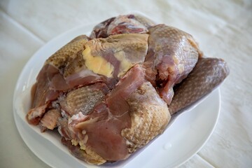 Traditional rustic Brazilian food, guinea fowl, Numida meleagris, with polenta, artisanal bread, and quinoa tabbouleh with vegetables. Real food