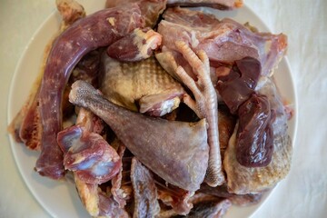 Traditional rustic Brazilian food, guinea fowl, Numida meleagris, with polenta, artisanal bread, and quinoa tabbouleh with vegetables. Real food
