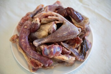 Traditional rustic Brazilian food, guinea fowl, Numida meleagris, with polenta, artisanal bread, and quinoa tabbouleh with vegetables. Real food