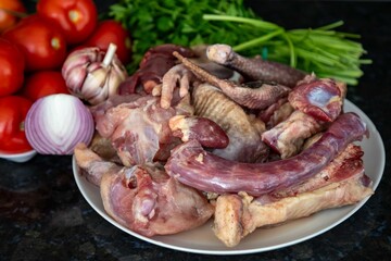 Traditional rustic Brazilian food, guinea fowl, Numida meleagris, with polenta, artisanal bread, and quinoa tabbouleh with vegetables. Real food