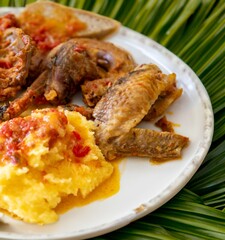 Traditional rustic Brazilian food, guinea fowl, Numida meleagris, with polenta, artisanal bread, and quinoa tabbouleh with vegetables. Real food
