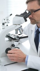 Medical scientist wearing gloves using microscope analyzing samples in modern laboratory doing scientific research. Medicine, healthcare and science concept
