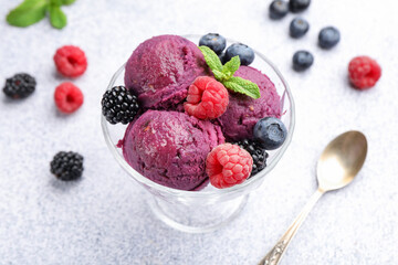 Delicious sorbet with fresh berries and mint in dessert bowl on grey textured table, closeup