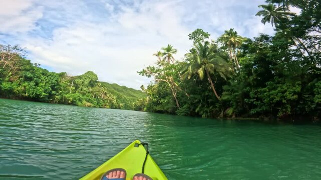 View from kayak on the green waters of Lobok river with tropical jungle in Bohol island, Philippines Kayaking on Lobok river surrounded by lush tropical forest on Bohol island, Philippines