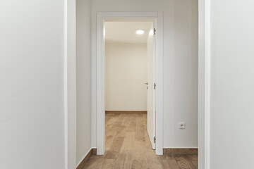 Functional corridor with integrated bench and hidden hangers, optimizing storage without sacrificing minimalist design
