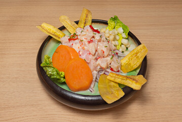 Classic perfectly cooked sea bass ceviche with julienned red onion, chopped cilantro, and drops of thick tiger's milk