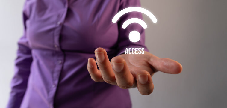 Businesswoman holding with her hand a Wi-Fi signal and access